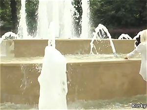platinum-blonde made to tub in public fountain